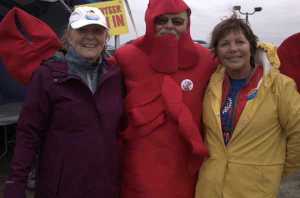 A grinning Rick Benson proudly sports the costume for the iconic mascot of Lobster Fest, ready to brave the steadily incoming storm alongside all the courageous volunteers stationed across the area.
