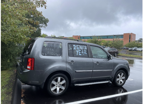 A senior girl’s car is seen parked outside of Staples. This car has a field hockey stick and ball painted on it as well as the commonly used phrase “2enior ye4r.”
