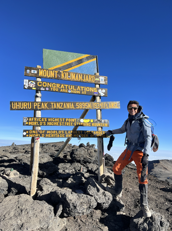 After more than four days of hiking, Haymond takes in the breathtaking view at Uhuru Peak, the highest Kilimanjaro peak. 
