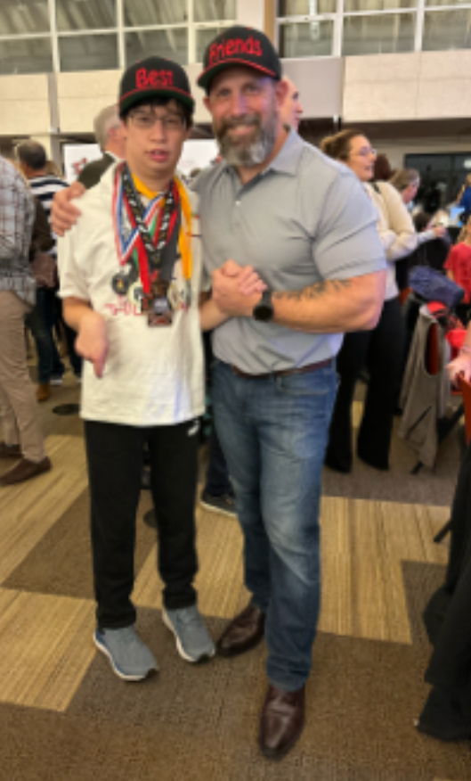 Awesome Austin” (left) and his chief angel Andrew Berman (right) show off the medals Austin has received after participating in MyTEAM TRIUMPH events
