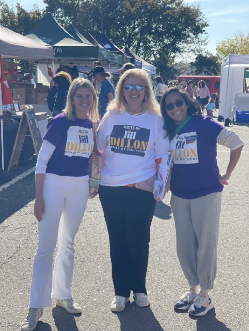 Jill Dillon and her team members stand outside in their logowear in order to spread the word about their campaign and educate voters about what makes their policy agenda unique.