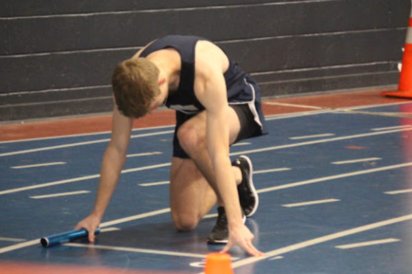 Oliver Galin ’25 gets in position to run the four by 200 meter relay. 
