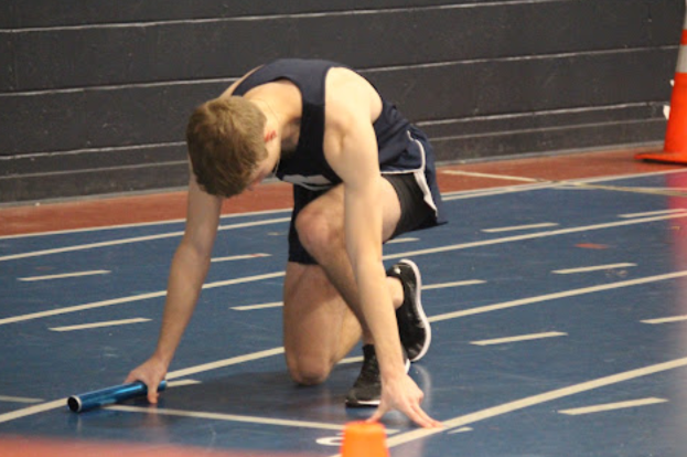 Oliver+Galin+%E2%80%9925+gets+in+position+to+run+the+four+by+200+meter+relay.+%28Photo+contributed+by+Oliver+Galin+25%29%0A