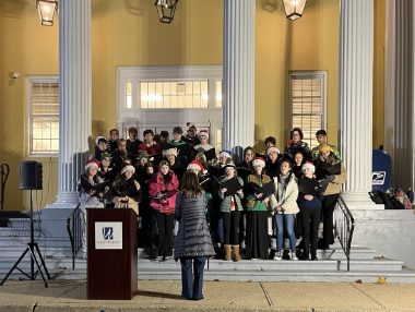 A group of carolers from Staples high school, known as the Staples Orphinians, sing Christmas carols in front of the tree lighting audience before the official lighting ceremony. The Orphinians sang a variety of the traditional Christmas carols, such as a jazzy version of Jingle Bells, Deck The Halls and Have Yourself A Merry Little Christmas.