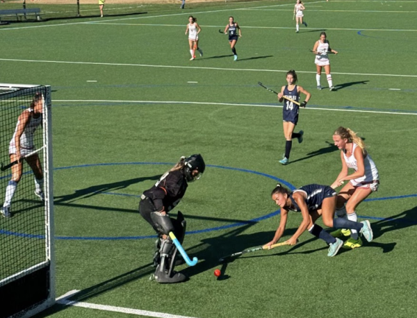 Daisy Hackett ’27 sprints towards goal as Greenwich defenders close in during the first quarter of Staples home opener. 