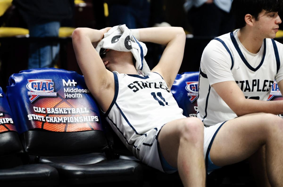 Mason Tobias ’26 sits on the bench in disbelief after the loss.
