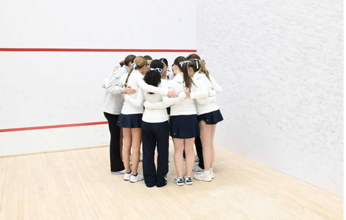 Staples girls’ squash team huddles up before their first match in Philadelphia to kick off the 2026 High School Nationals. 