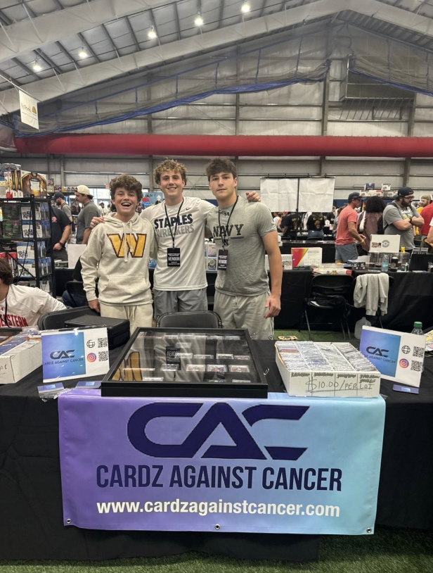 Peter Klopfer ’27, Asher Vengrow ’27 and Jonah Bomback ’27 (left to right) pose at a card show. Photo contributed by Cardz Against Cancer