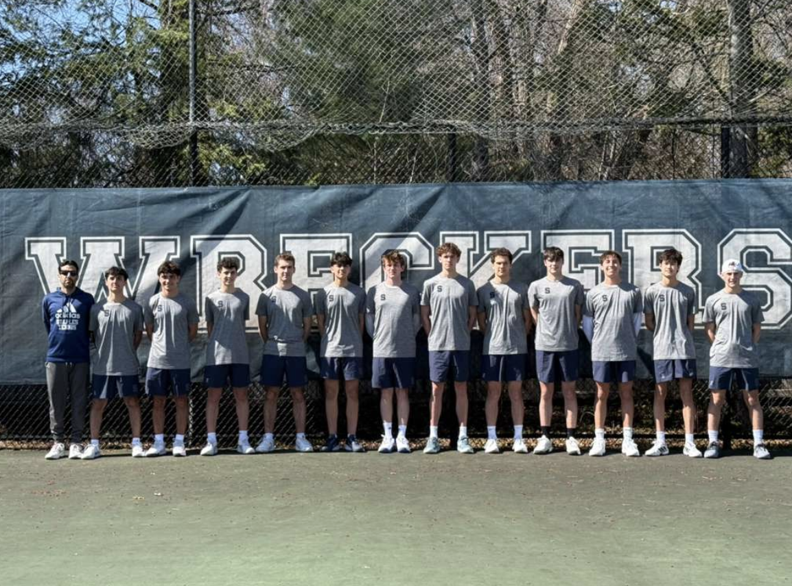The Staples boys’ tennis team poses for a group photo at their home court.